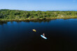 © Tropical studio - Active kids have a fun on kayak and stand up paddle SUP board in sea lagoon. Healthy lifestyle. Recreational water sport, SUP tour in adventure camp on family summer beach vacation