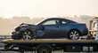 © Dmitry - Blue salvage car on tow truck. Vehicle recovery service transporting wrecked automobile after accident. Roadside assistance and car crash concept.