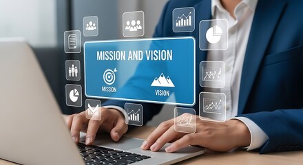 Businessperson using laptop with mission and vision concept floating user interface