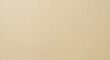 © premium seller - Close up of a beige fabric texture with a woven pattern and a subtle light and shadow effect visible