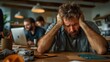 © Larisa AI - A distressed man visibly expressing frustration amidst a busy workplace, capturing the emotional weight of stress in a contemporary office environment filled with activity.