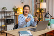 © Andrii Iemelianenko - Happy Indian woman freelancer using bank credit card and smartphone for online shopping payments at home office. Business transaction. Smiling girl purchase with phone E-banking app service. Lifestyle