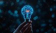 © HADI INCREDIBLE - Hand holding glowing brain lightbulb against bokeh background