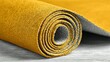 © ganva - Rolled up piece of mustard yellow fabric.