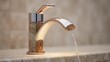 © The Little Hut - Elegant modern bathroom faucet with a curved spout and sleek metallic finish mounted on a beige marble countertop with flowing water