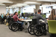 © Pual GotoMars - Active employees wheelchairs working modern office environment, showcasing inclusivity