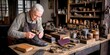 © Atmospheric stock - Elderly caucasian male cobbler crafting leather boot in traditional workshop setting