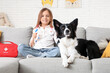 © Pixel-Shot - Cute little girl with toy stethoscope and dog on sofa at home
