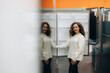 © Roman - Young Woman Smiling While Shopping for Refrigerators in an Electronics Store
