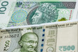 © Andrzej - 100 Polish zloty and 500 Indian rupee banknotes. International trade concept