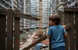 © Thatchakon - Young kids in close quarters within a bustling cityscape, illustrating childhood amidst urban population growth on World Population Day