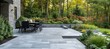 © Sitti - Modern patio with outdoor dining area overlooking lush landscaping