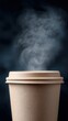 © Newvie - A close-up of a steaming hot beverage in a textured disposable cup with a lid against a dark background.