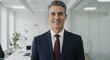 ©  S u n n y B u n n y - Confident Middle-Aged Businessman in Tailored Suit Standing in Modern Office Space, Radiating Professionalism and Approachability with Bright and Inviting Atmosphere