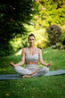 © sepy - Attractive woman wearing sports clothes and doing yoga in the garden at home