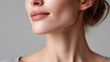 © JoeyMarut - Soft closeup of woman chin and lips with smooth skin and natural makeup, showing gentle smile and delicate jawline against neutral background