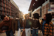 © bernardbodo - Group of young diverse friends walking and talking together in Madrid at sunset