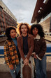 © bernardbodo - Young urban friends holding skateboard posing in the city