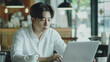 © olgakudryashova - Young handsome Korean man working on laptop in cafe. Work in a cafe, freelance, free business, young businessman