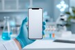 © Руслан Галиуллин - hand with blue glove holding smartphone with white screen against laboratory, mock up, analysis results