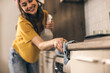 © milanmarkovic78 - A Woman Cleaning A Kitchen With A Rag