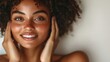 © svastix - A radiant young woman with curly hair and freckles smiles warmly, highlighting natural beauty and confidence, a celebration of individual charm and self-acceptance.