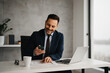 © Novak - Handsome businessman in suit working in his office