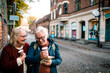 © Davor - Senior women laughing while reading city map on vacation