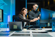 © Kritdanai - Business Professionals Collaborating on Computer at Night