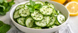 © Mcgui - Fresh Cucumber Salad with Mint and Lemon in a White Bowl