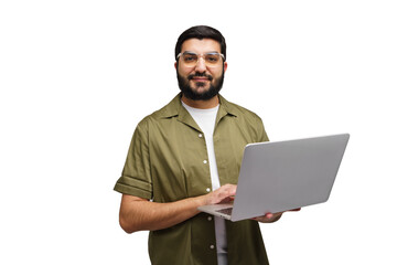 Man in a green shirt smiles while holding an open laptop, fingers poised over the keys, ready to work on a sunny afternoon in the office