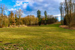 © Iurii Gagarin - Tranquil autumn landscape with open field and bare trees under cloudy sky