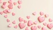 © Muaz - Scattered pink heart candies on a light background for valentine's day