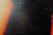 © Uuganbayar - grungy black texture with vintage scratches and orange light leak for edgy web design, print media background, and creative branding graphics