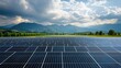 © Sitti - Vast solar panel farm stretches across a valley, with mountains in the background under a partly cloudy sky