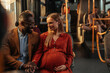 © bernardbodo - Pregnant woman sitting with her husband on a bus
