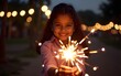 © wang - Indian pretty young girl playing with sparklers in diwali festival night. High quality