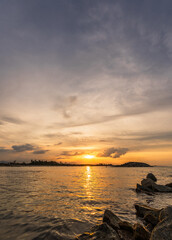 Wall Mural - sunset sea vertical background in the evening, summer sky with orange, yellow, blue sunrise clouds s