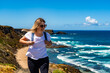 © Jacek Chabraszewski - Beautiful middle aged woman tourist hiking on trail along atlantic ocean in nature park Vicentine Coast in Algarve in Portugal on spring day. Front view