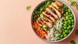 © Arslan - Top view of a bowl with grilled chicken rice edamame carrots and greens on a light pink background