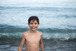 © Antonio Recena - 9-year-old boy on the beach with smiling wet looking at the camera