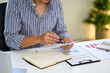 © Prathankarnpap - Young entrepreneur checking business data at home workspace