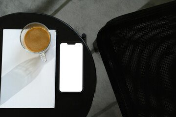 Wall Mural - top view of smartphone mockup with coffee and book on on a sleek black table