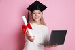 © New Africa - Happy student with diploma and laptop after graduation on pink background