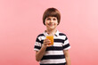© New Africa - Cute little boy with glass of orange juice on pink background. Refreshing drink