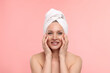 © New Africa - Beautiful woman with towel wrapped on her head against light pink background
