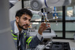 © Nassorn - Latino robotic development engineer working robot arm connection control at electronic futuristic science laboratory. Hispanic technician learning innovation machine in automated engineering academy.