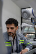 © Nassorn - Latino robotic development engineer working robot arm connection control at electronic futuristic science laboratory. Hispanic technician learning innovation machine in automated engineering academy.