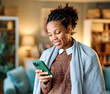 © Lumos sp - Portrait of a sick young black woman using a smart phone and texting at home, virus or flu illness, recovery at home