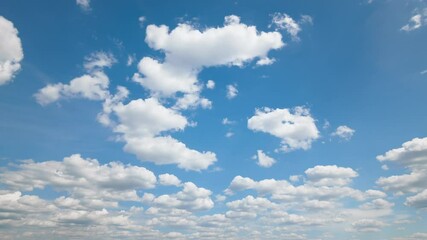 Wall Mural - a beautiful blue sky with soft, white clouds, captured in a timelapse for an abstract background
